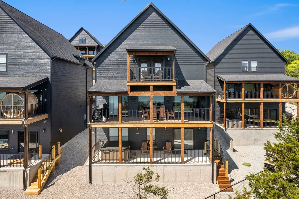 The exterior of Rocky Shores, showcasing expansive wooden balconies and modern architecture designed for large groups to gather, relax, and enjoy scenic views. The welcoming and contemporary look hints at the spaciousness and comfort inside.